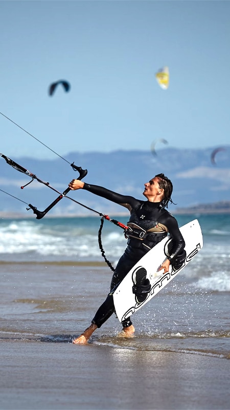 Kitesurfer walking out of the water at the Delta