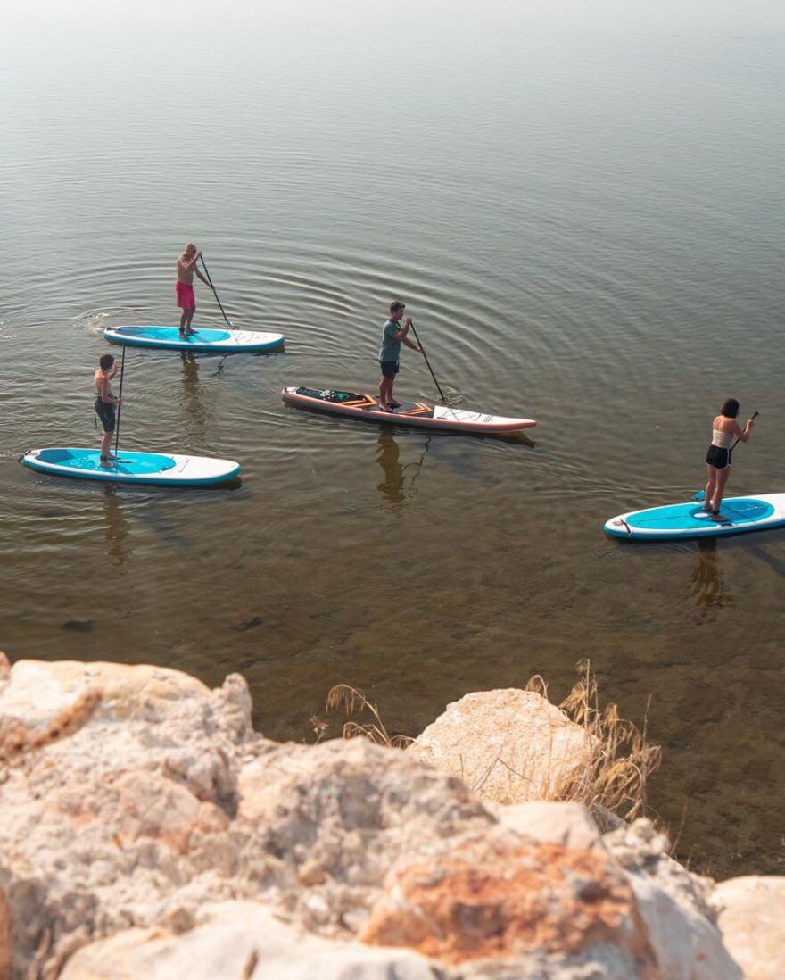 Paddleboarders gliding on a calm Delta lagoon